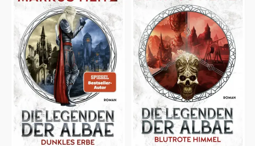 Zwei Buchcover von Markus Heitz: "Die Legenden der Albae - Dunkles Erbe" mit einem Elfen vor einer düsteren Stadt und "Die Legenden der Albae - Blutrote Himmel" mit einem Totenkopf vor einer apokalyptischen Landschaft.