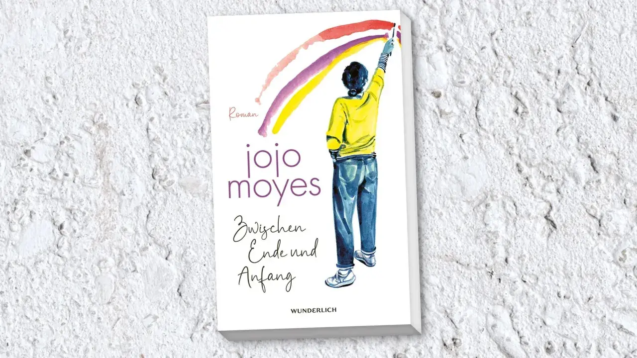 Ein Buchcover von Jojo Moyes mit einer Person, die einen Regenbogen malt. Der Titel lautet "Zwischen Ende und Anfang".